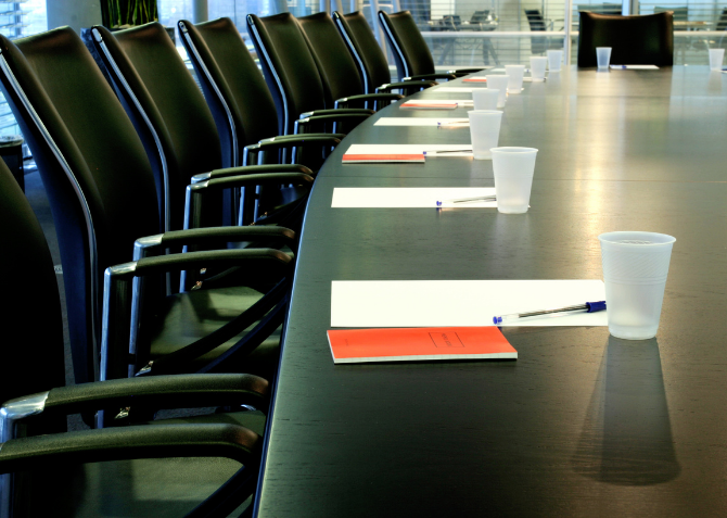 Table with chairs and a packet at each seat