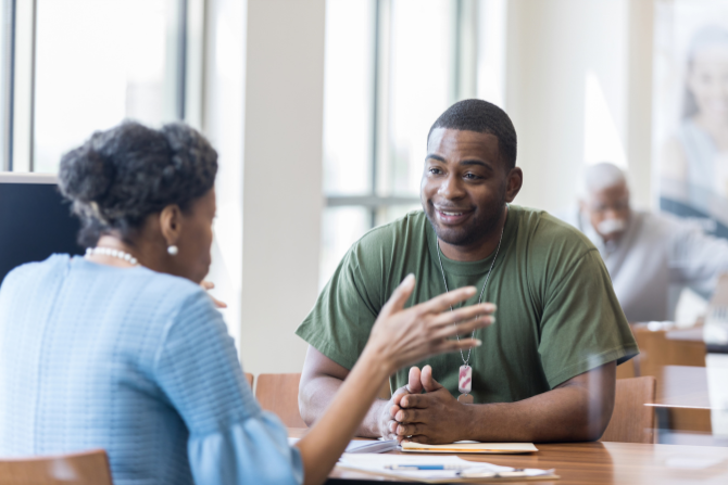 Credit union employee meeting with veteran