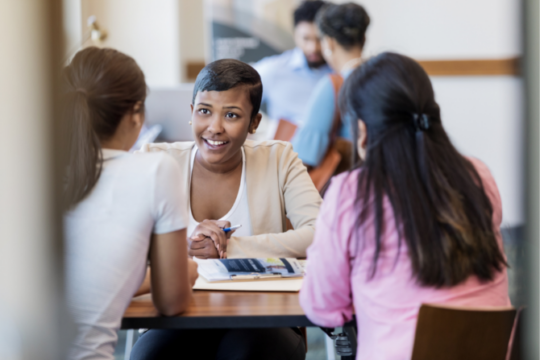 Credit union employee speaking with two members