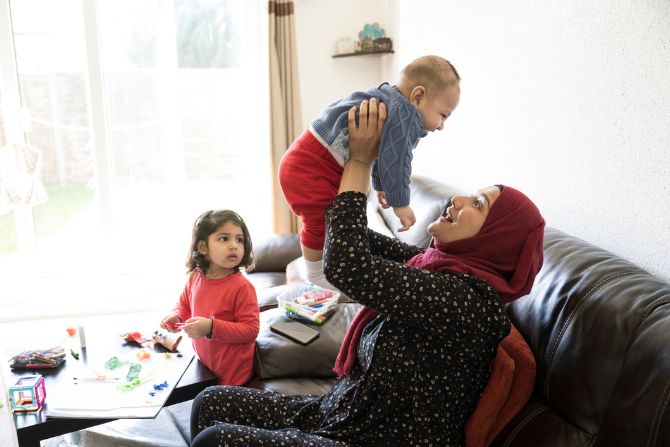 A young mother with a head scarf