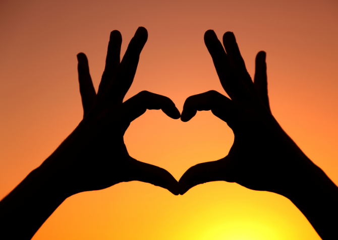 heart with hands in sunset