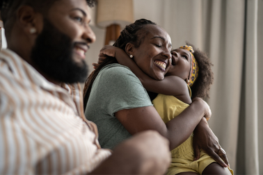 Girl embracing mom at home