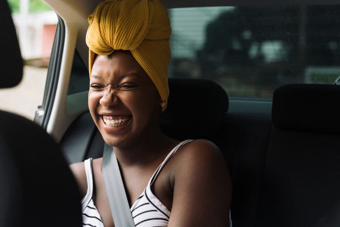 A young Black woman, smiling