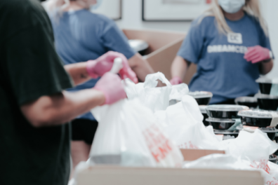 People volunteering to pack hot meals.