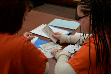 Two incarcerated individuals take part in financial education training