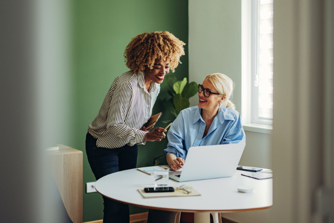 Two women working together at a desk