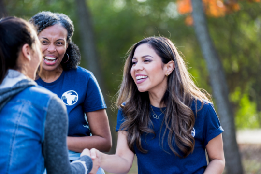 Women smiling and volunteering