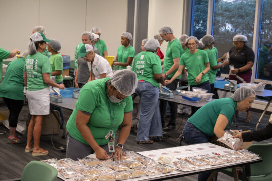 Coastal CU employees packaging food for their DE Day of Service Project