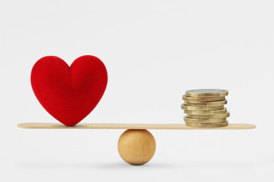 heart and money on a balance