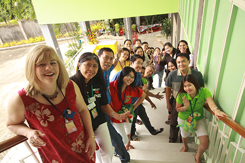 large group of smiling people on stairs