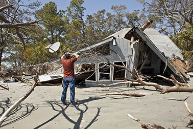 man holding head looking at disaster