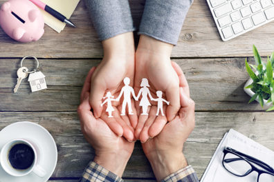 hands holding a paper family