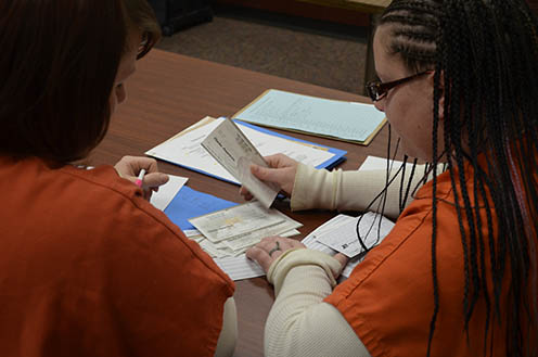 inmates handeling money