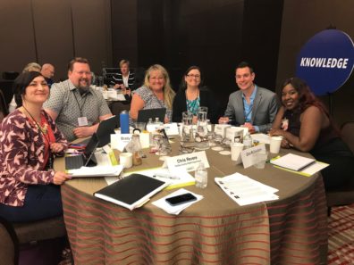 diverse group of people gathered at awards dinner table