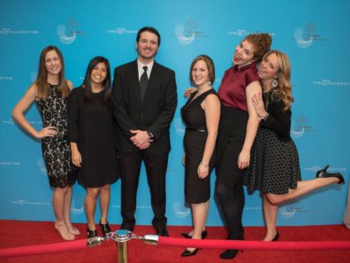 small group of well dressed people on red carpet