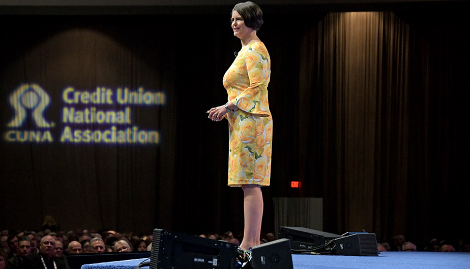 well dressed woman standing at podium speaking