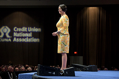 well dressed woman standing at podium speaking