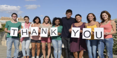 group of people holding up letters that spell "thank you"