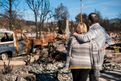 Couple viewing their destroyed home from wildfires